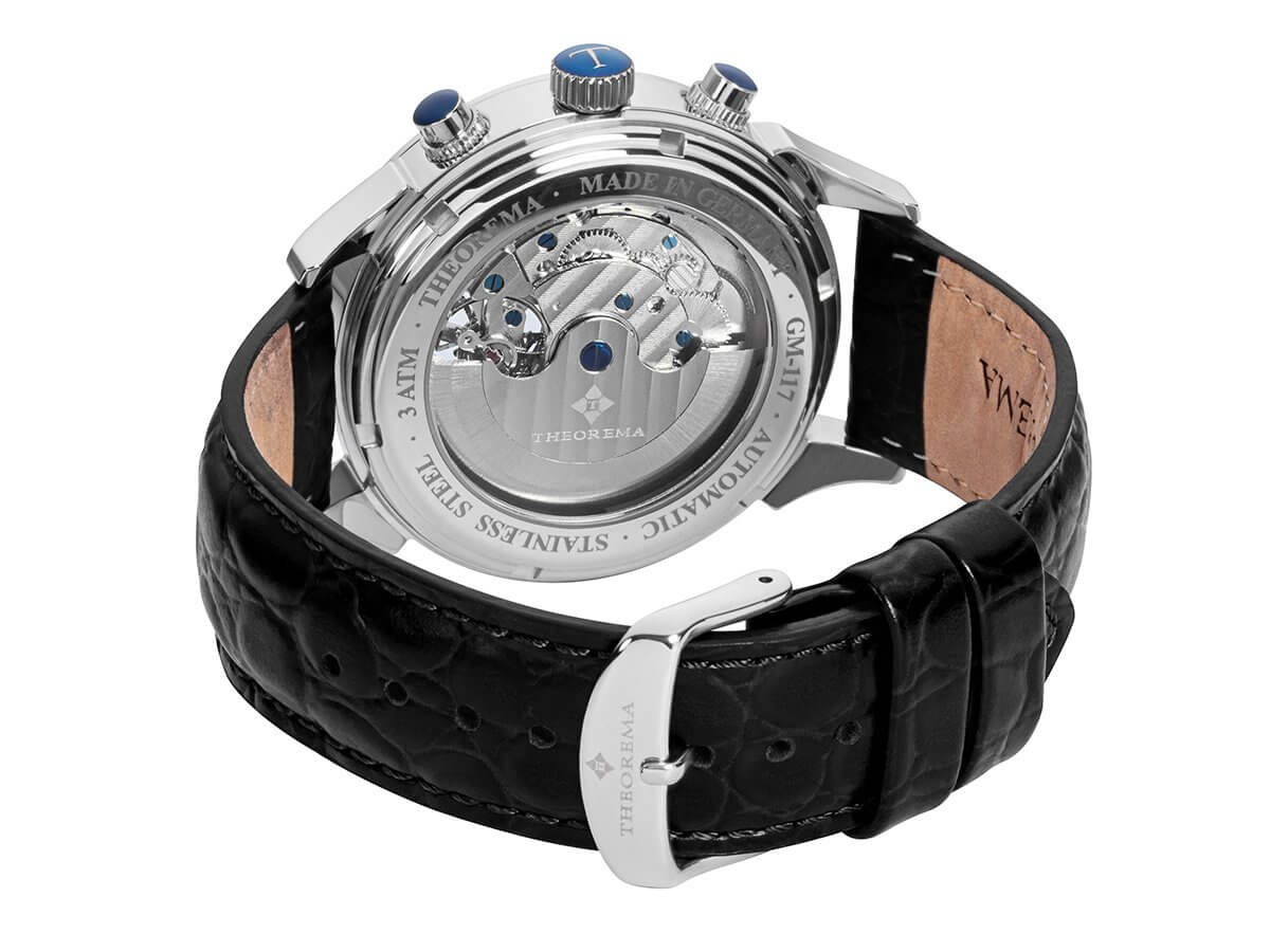 Open back case with silver mechanism and visible gears inside and a standard buckle for the band.